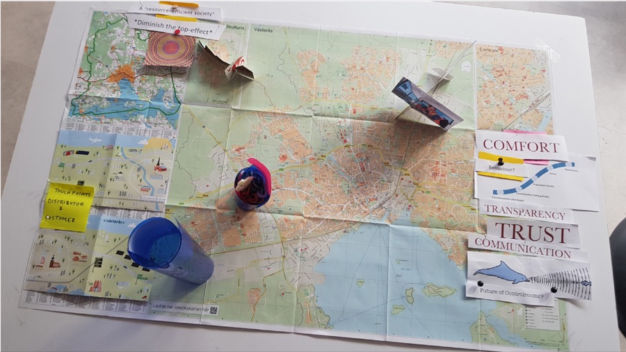 A city map on a table with notes, figures and cards saying comfort, trust and communication, from a workshop